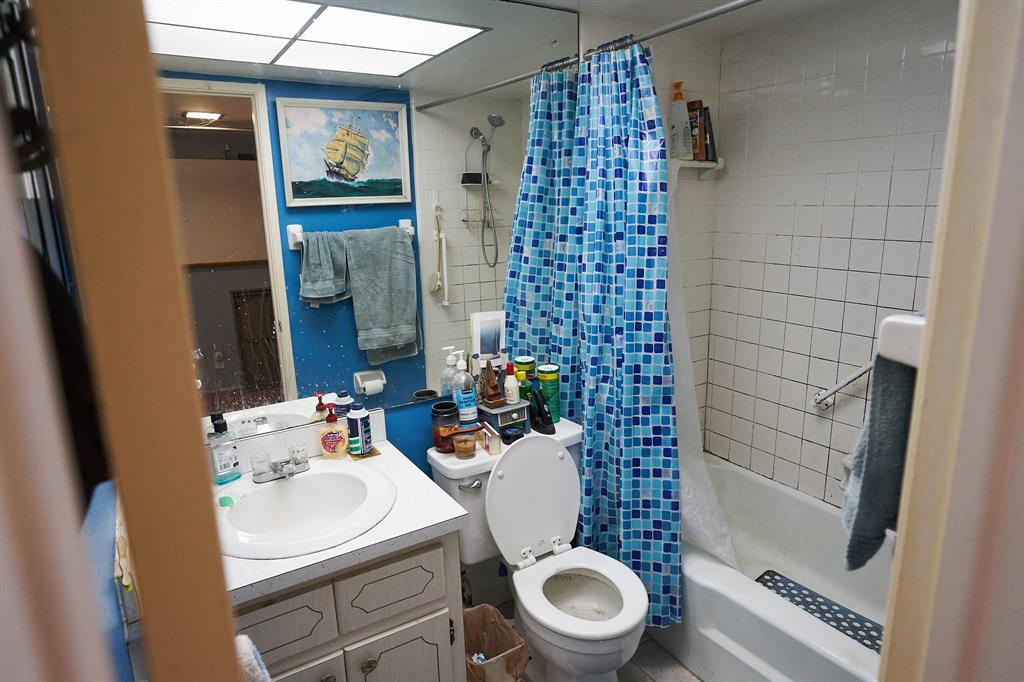 651 Pine Drive, Unit 201 Pompano Beach, FL 33060 - Photo 11 of 18 a bathroom with a sink a toilet and shower