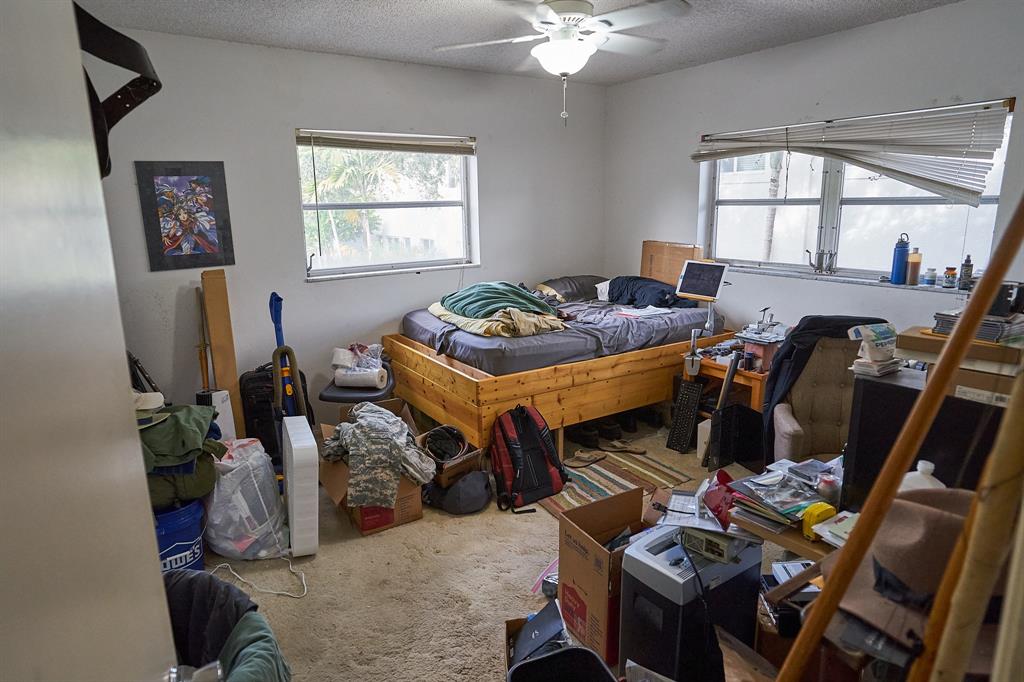 651 Pine Drive, Unit 201 Pompano Beach, FL 33060 - Photo 12 of 18 a living room with furniture a window and a flat screen tv