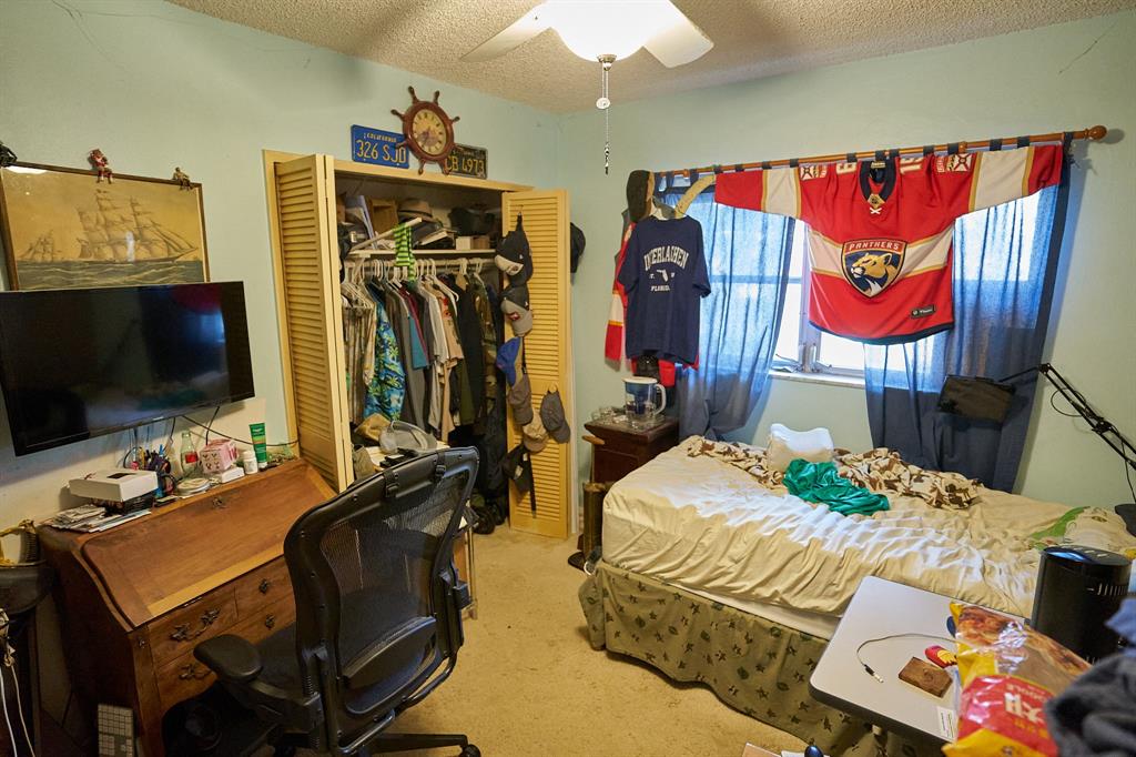 651 Pine Drive, Unit 201 Pompano Beach, FL 33060 - Photo 15 of 18 a bedroom with furniture and a flat screen tv