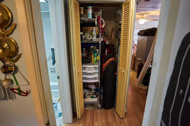 a view of walk in closet with clothes and shoes