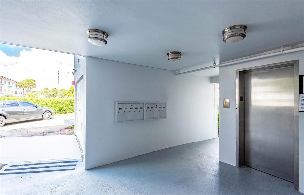 651 Pine Drive, Unit 201 Pompano Beach, FL 33060 - Photo 4 of 18 a view of hallway with a large window