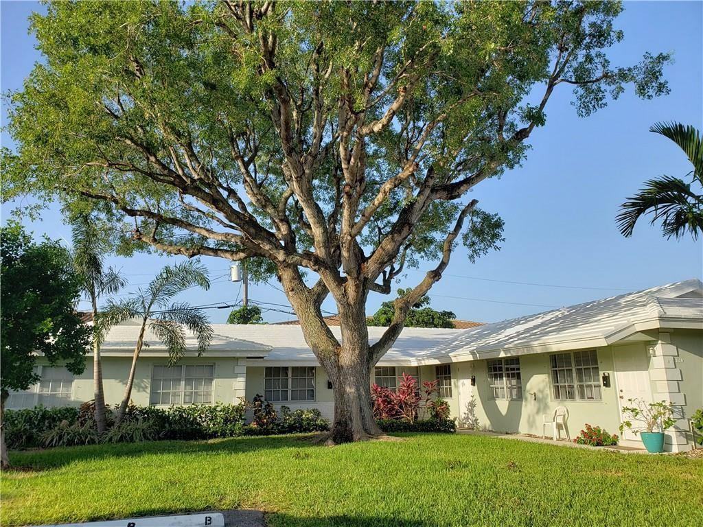 2120 Northeast 41st Street, Unit B Lighthouse Point, FL 33064 - Photo 1 of 24 a front view of a house with garden