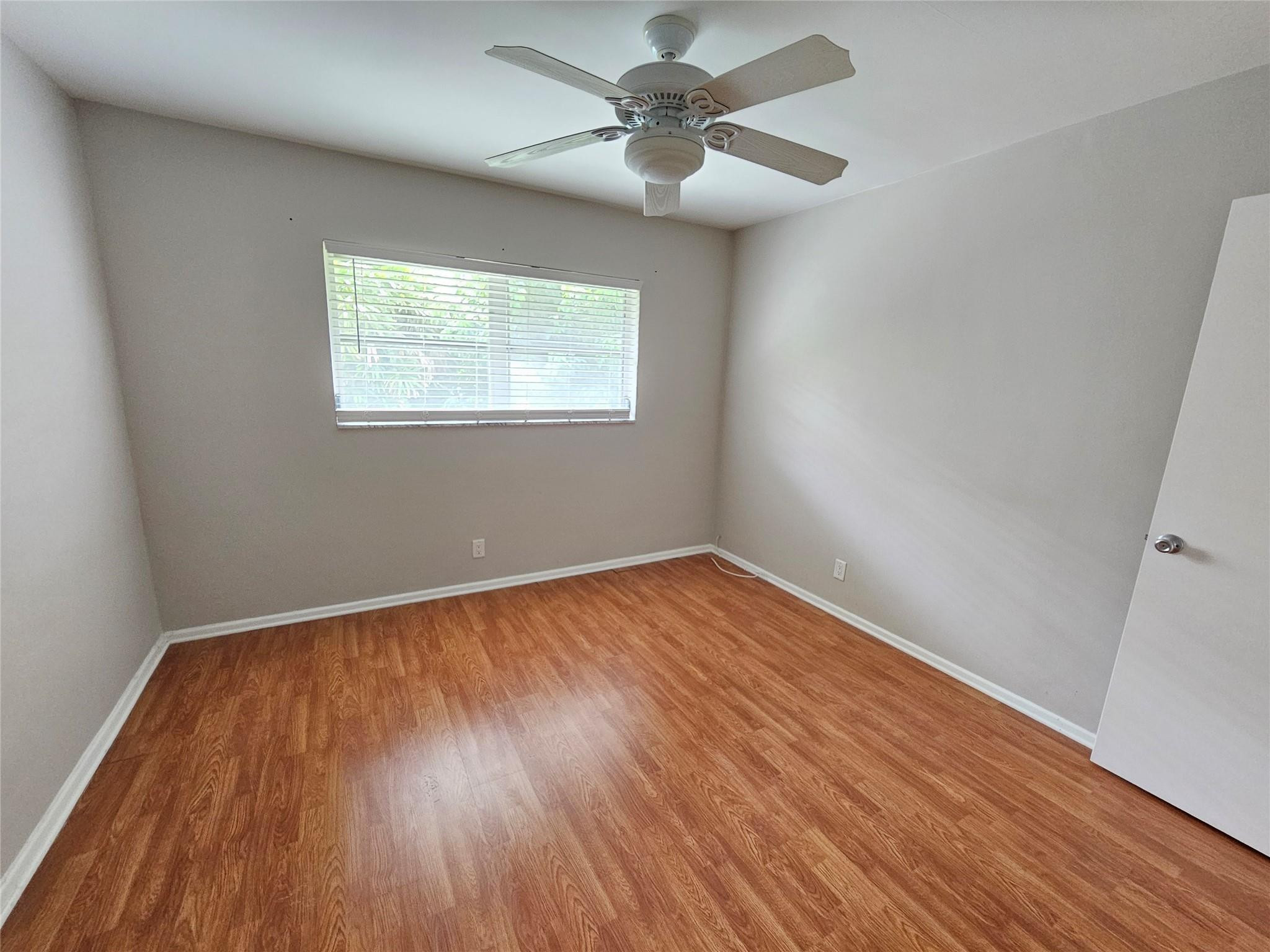 2120 Northeast 41st Street, Unit B Lighthouse Point, FL 33064 - Photo 16 of 24 wooden floor in an empty room with a window