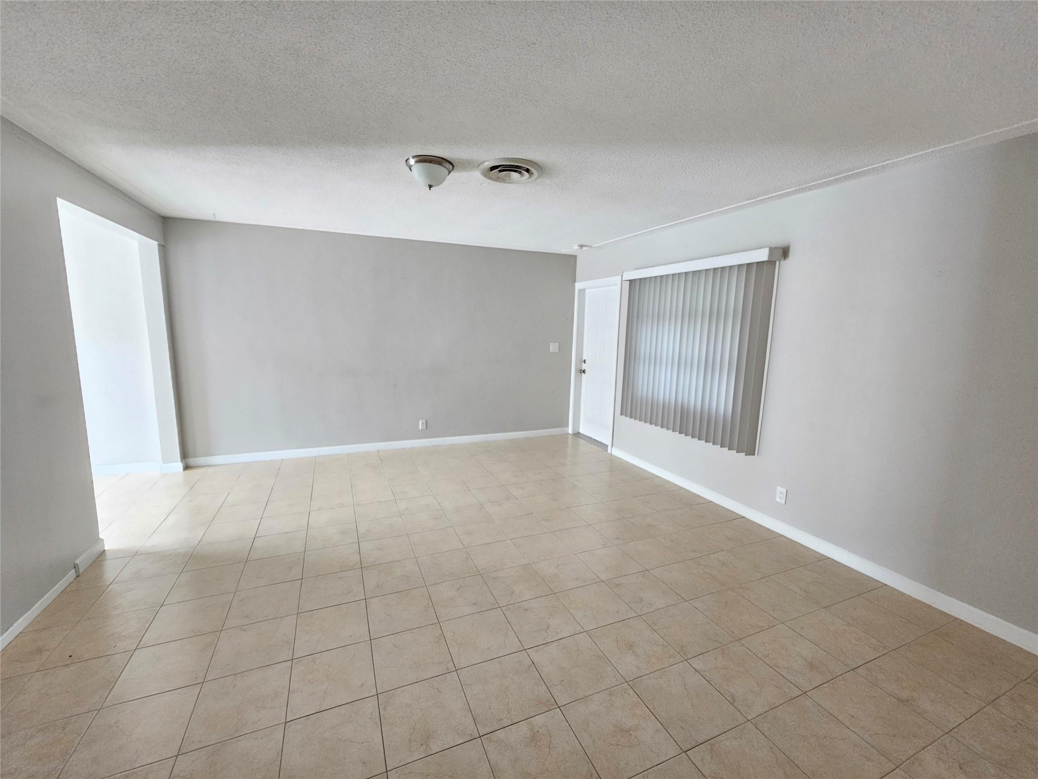 2120 Northeast 41st Street, Unit B Lighthouse Point, FL 33064 - Photo 19 of 24 an empty room with windows