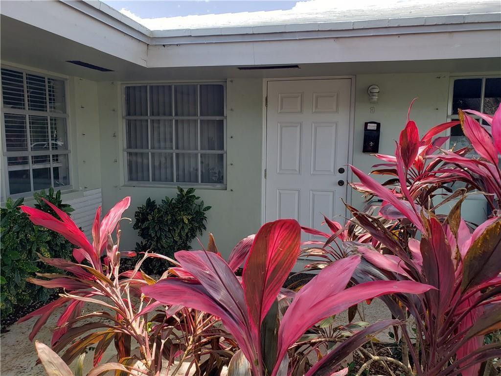 2120 Northeast 41st Street, Unit B Lighthouse Point, FL 33064 - Photo 2 of 24 a view of a house with a bed and chair
