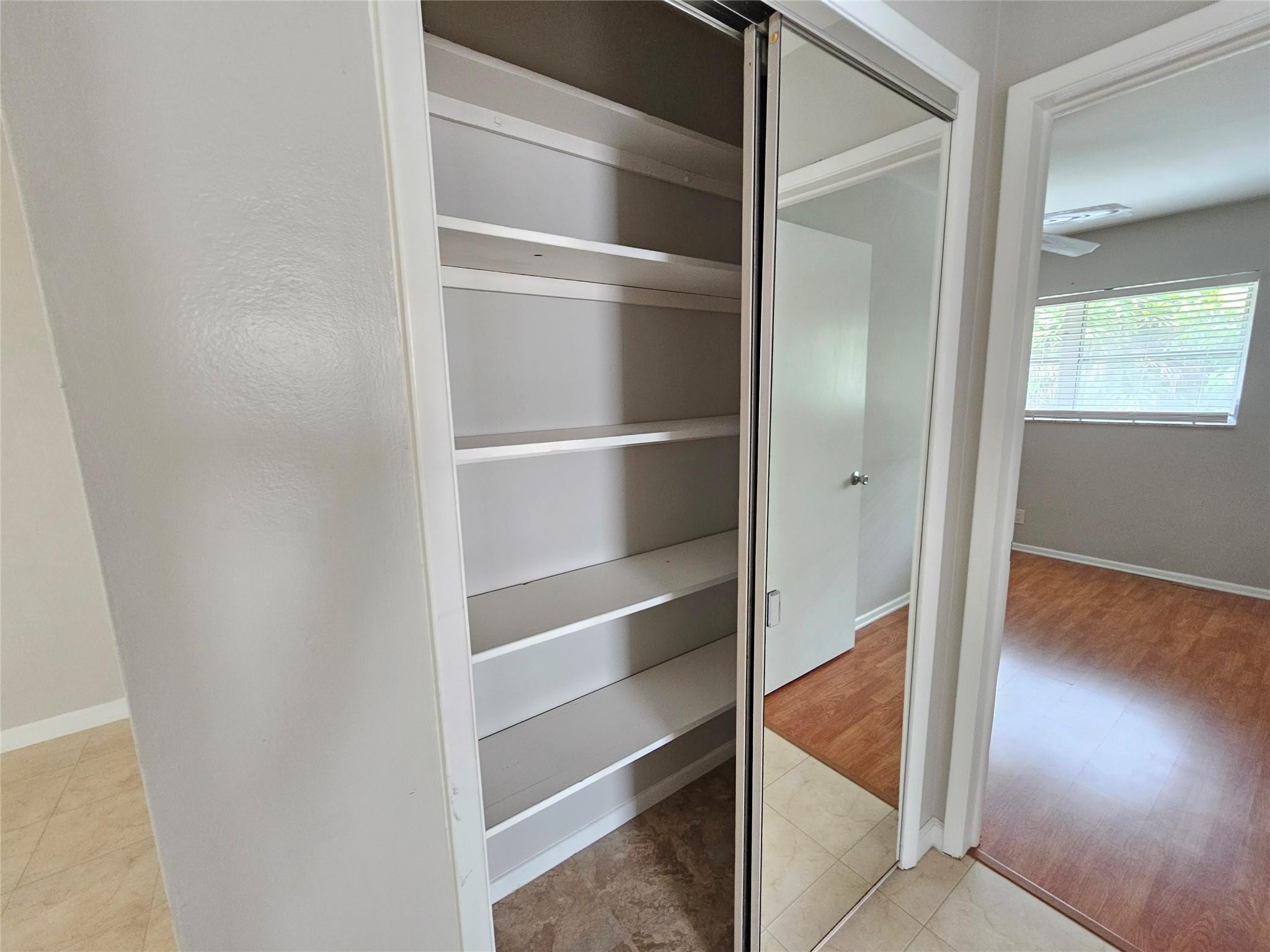 2120 Northeast 41st Street, Unit B Lighthouse Point, FL 33064 - Photo 21 of 24 a view of walk in closet with empty racks