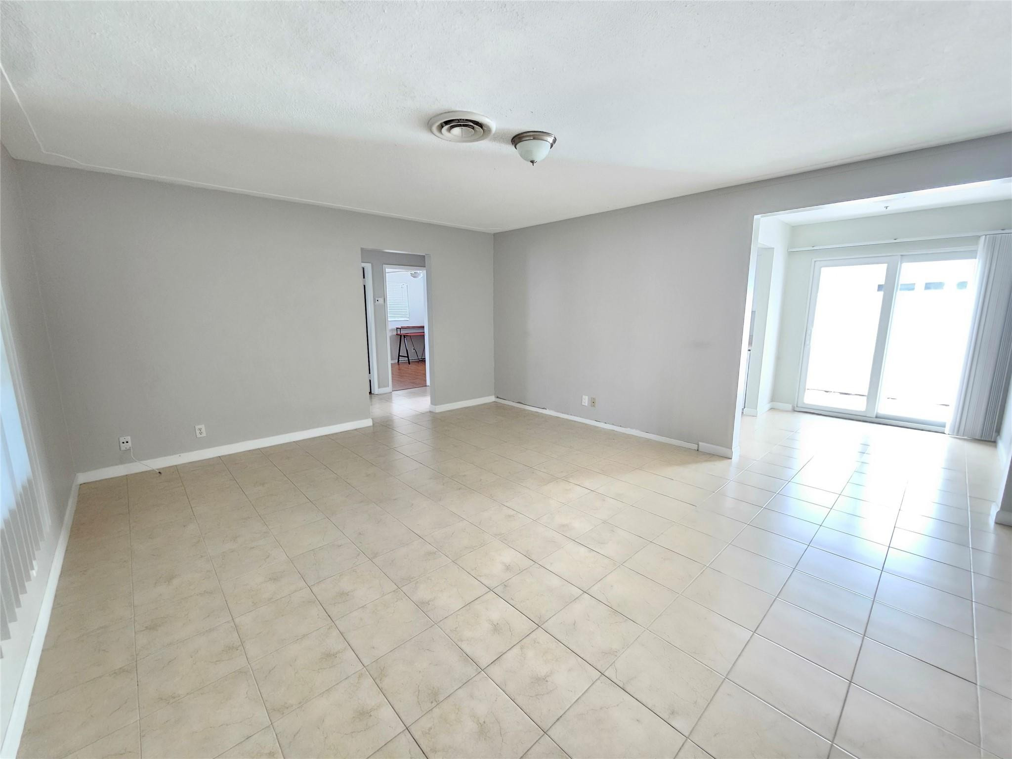 2120 Northeast 41st Street, Unit B Lighthouse Point, FL 33064 - Photo 4 of 24 an empty room with windows