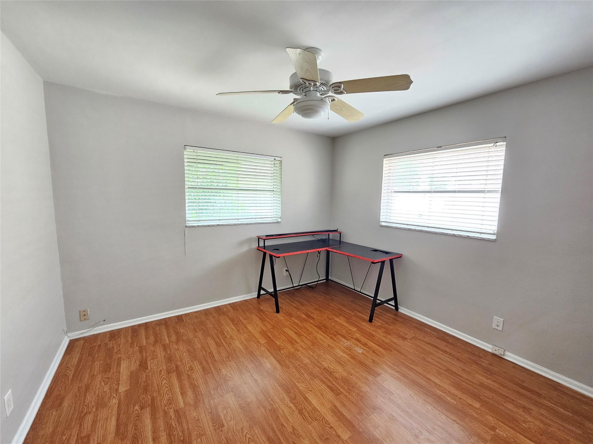 2120 Northeast 41st Street, Unit B Lighthouse Point, FL 33064 - Photo 8 of 24 a room with window and a wooden floor
