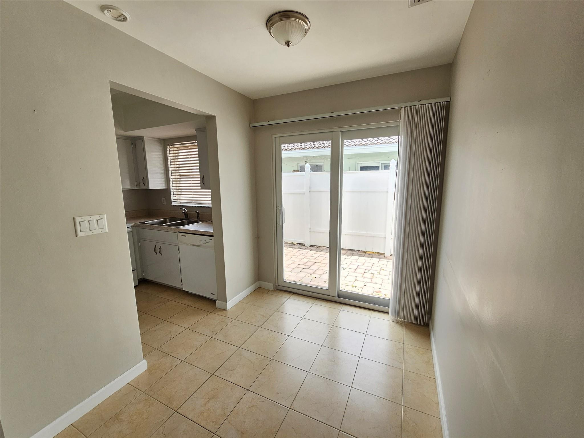 2120 Northeast 41st Street, Unit B Lighthouse Point, FL 33064 - Photo 10 of 24 a view of an empty room with a fireplace and a window