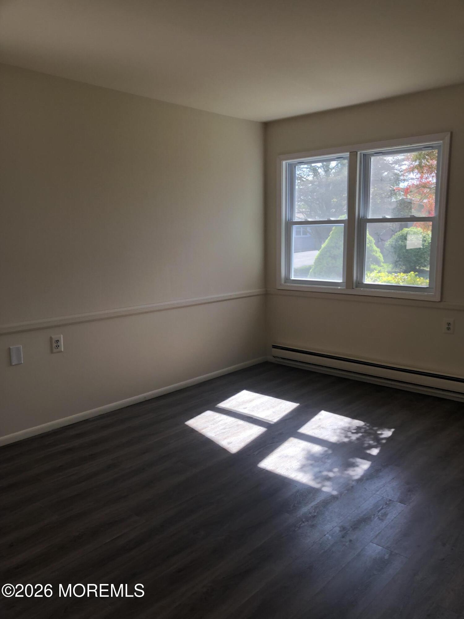 6 Dickinson Road Brick, NJ 08724 - Photo 13 of 17 an empty room with wooden floor and windows