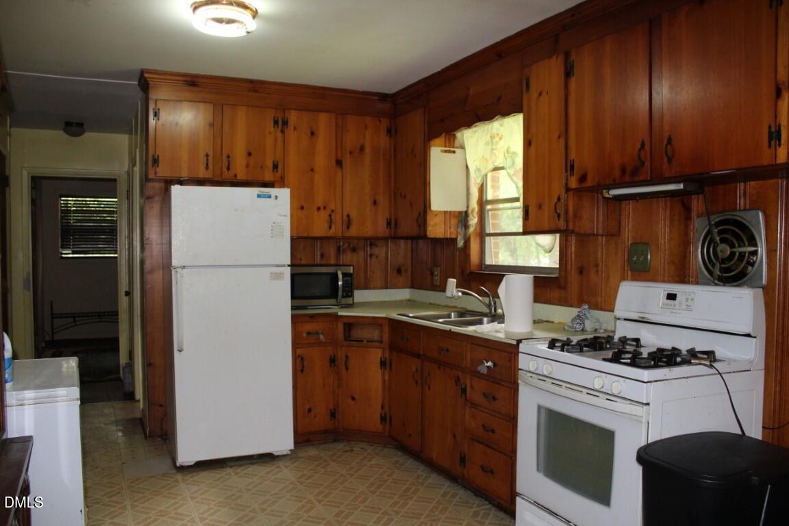 5109 Kaplan Drive Raleigh, NC 27606 - Photo 5 of 13 a kitchen with a refrigerator sink and cabinets