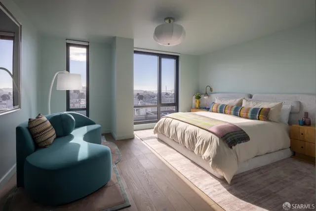 a spacious bedroom with a bed and a couch