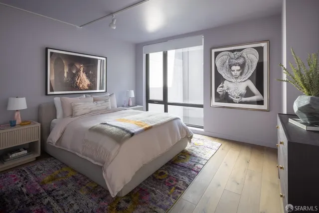 a bedroom with bed and wooden floor