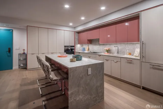 a kitchen with a sink a stove a refrigerator cabinets and dining table