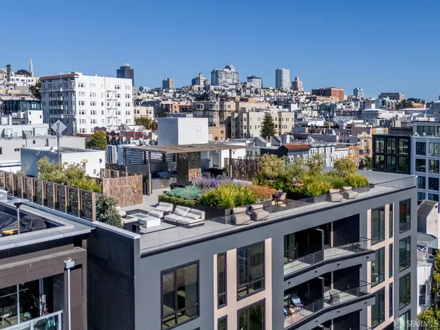 an aerial view of a residential houses with yard
