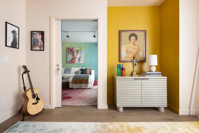 a view of a bedroom with a bed and wooden floor