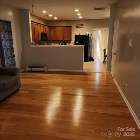 a view of kitchen with furniture and wooden floor