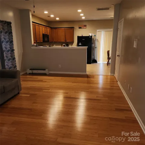 a view of kitchen with furniture and wooden floor