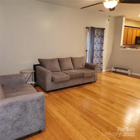 a living room with couches and painting on the wall