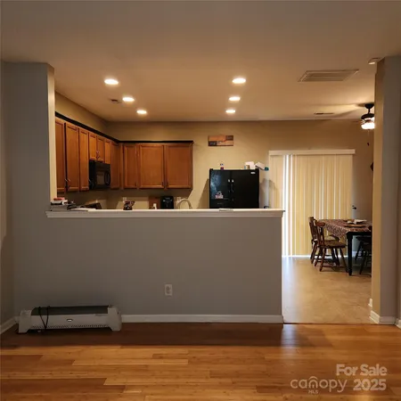 a kitchen with stainless steel appliances granite countertop a refrigerator sink and cabinets