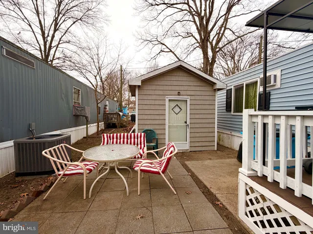 a view of a chairs and table in backyard of the house