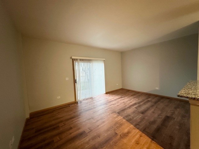 2446 Oak Tree Lane, Unit 2446 Plainfield, IL 60586 - Photo 3 of 11 a view of an empty room and wooden floor