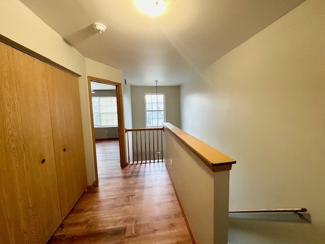 2446 Oak Tree Lane, Unit 2446 Plainfield, IL 60586 - Photo 6 of 11 a view of a hallway with wooden floor and staircase