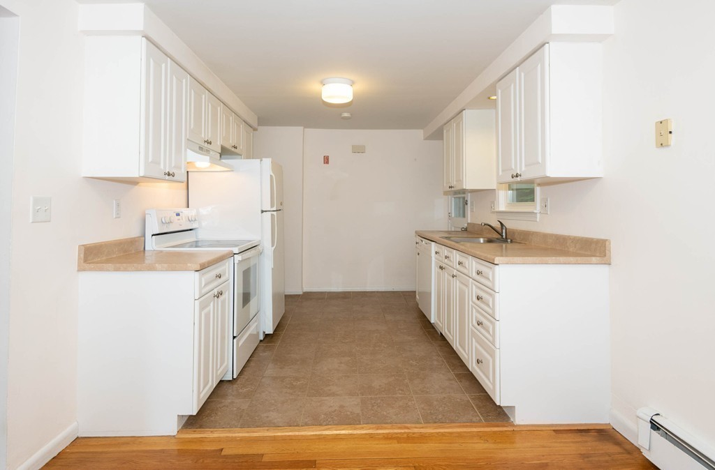 28 Charles Road, Unit 28 Winchester, MA 01890 - Photo 11 of 28 a kitchen with granite countertop a sink and cabinets