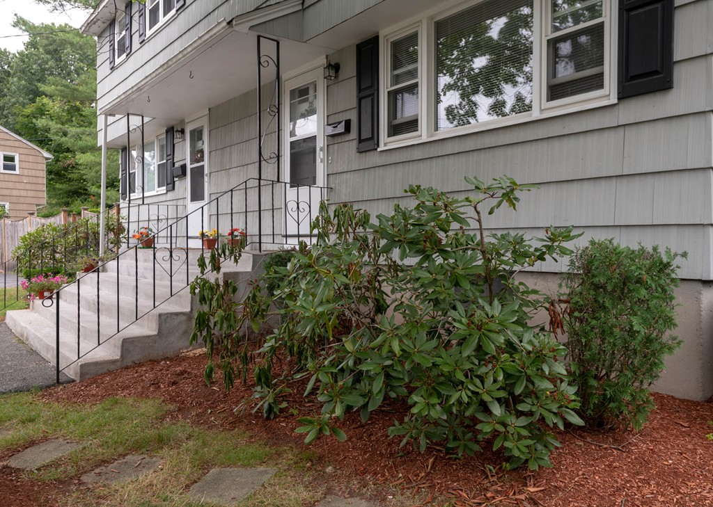 28 Charles Road, Unit 28 Winchester, MA 01890 - Photo 28 of 28 a view of a house with a flower garden