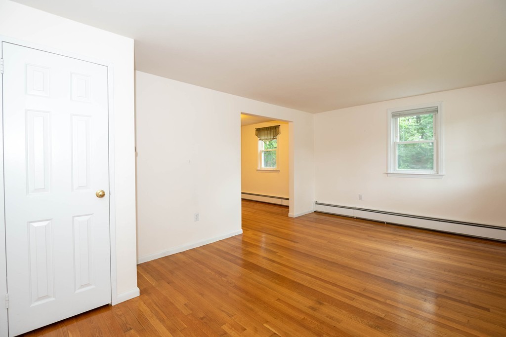 28 Charles Road, Unit 28 Winchester, MA 01890 - Photo 3 of 28 an empty room with wooden floor and windows