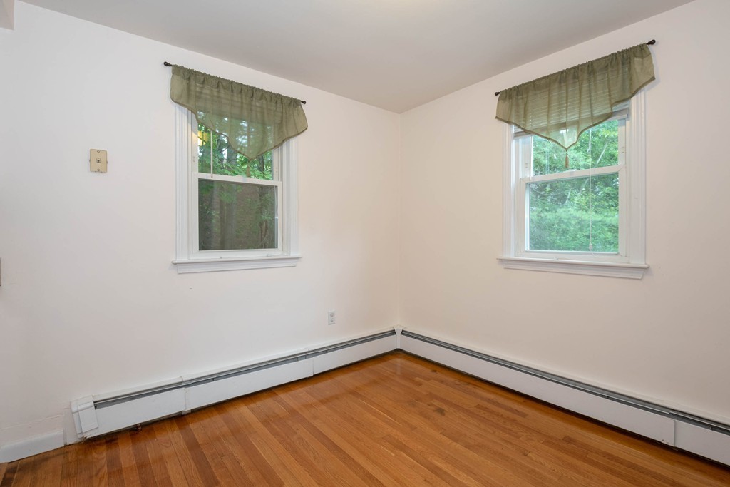 28 Charles Road, Unit 28 Winchester, MA 01890 - Photo 7 of 28 an empty room with wooden floor and windows