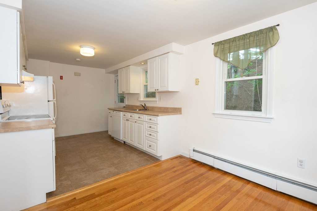28 Charles Road, Unit 28 Winchester, MA 01890 - Photo 9 of 28 a kitchen with a refrigerator and window