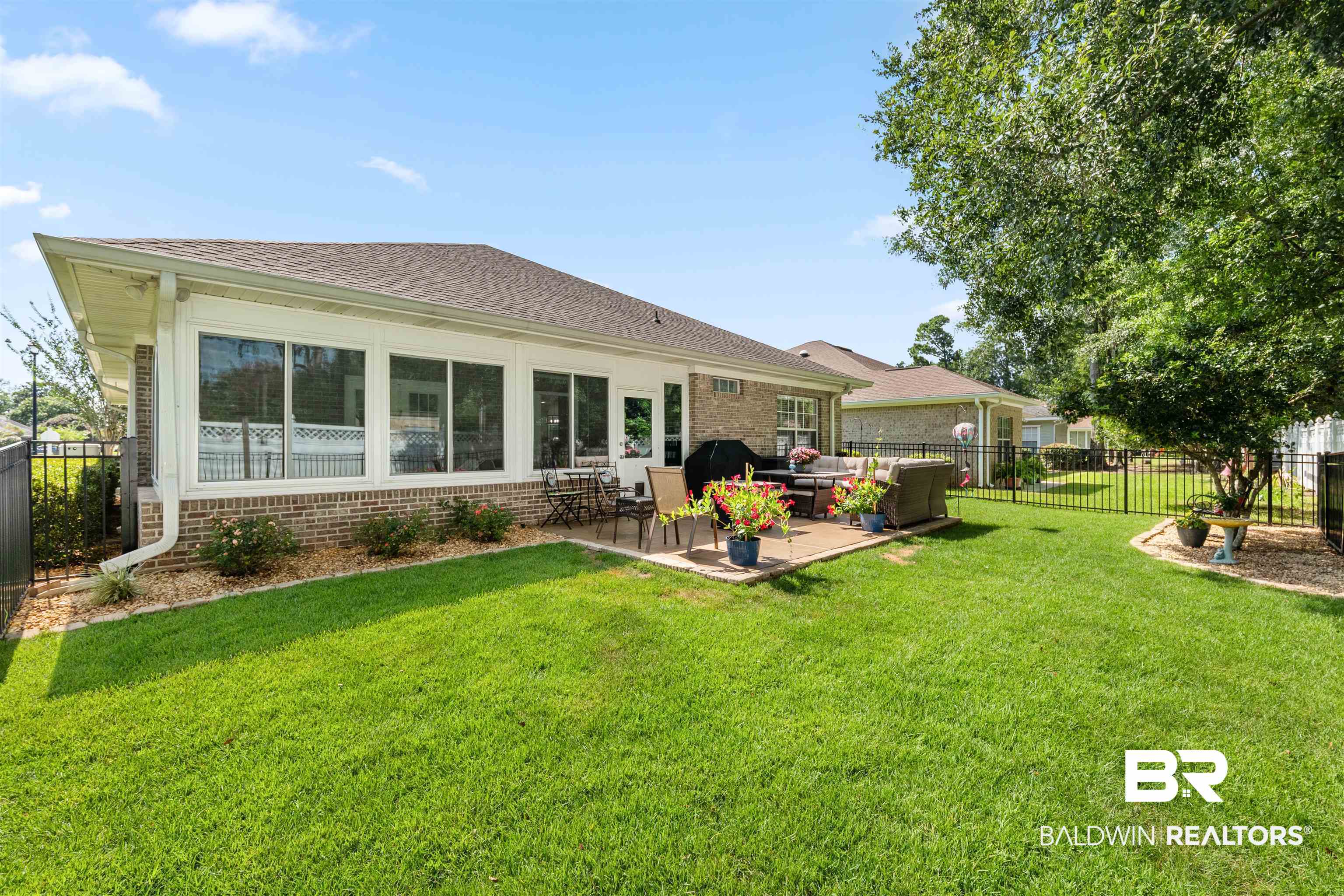 141 Mark Twain Loop Foley, AL 36535 - Photo 32 of 55 Back of house with brick siding, a fenced backyard, an outdoor hangout area, and a patio