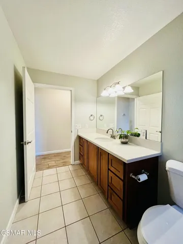 a bathroom with a sink a toilet and mirror