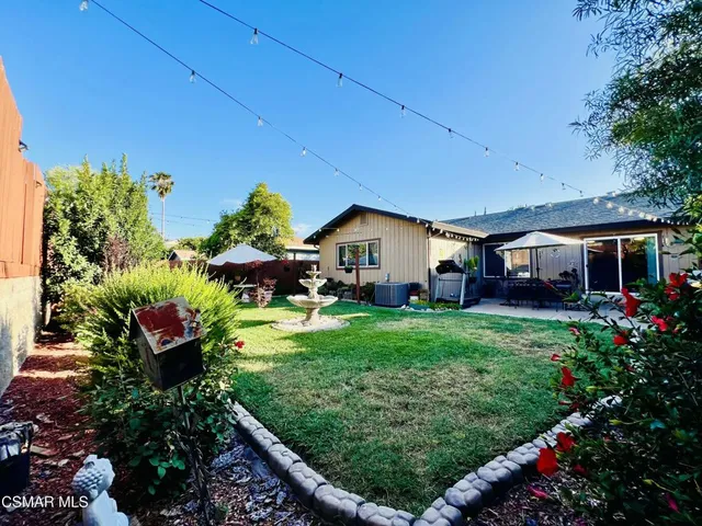 a view of a backyard with potted plants and a garden