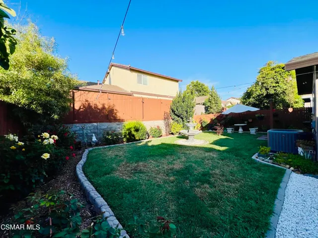a view of a chair and table in the garden