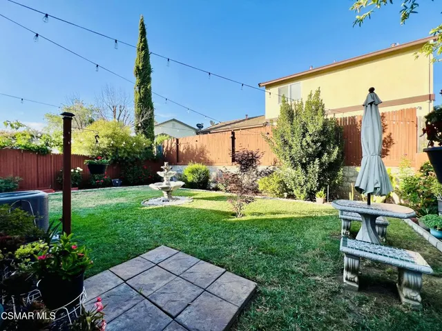 an aerial view of a house with yard