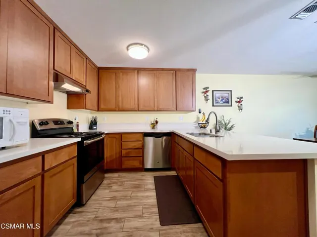 a kitchen with a sink stove and cabinets