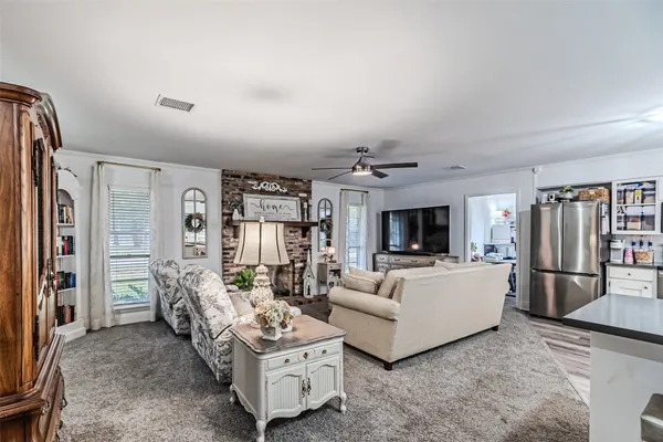 a dining room with furniture and a kitchen