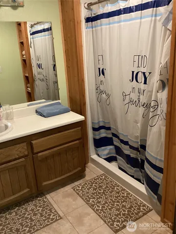 a living room with furniture a large window and a rug