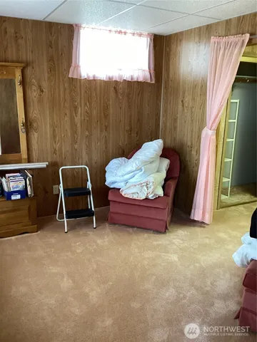 a living room with a couch and large windows