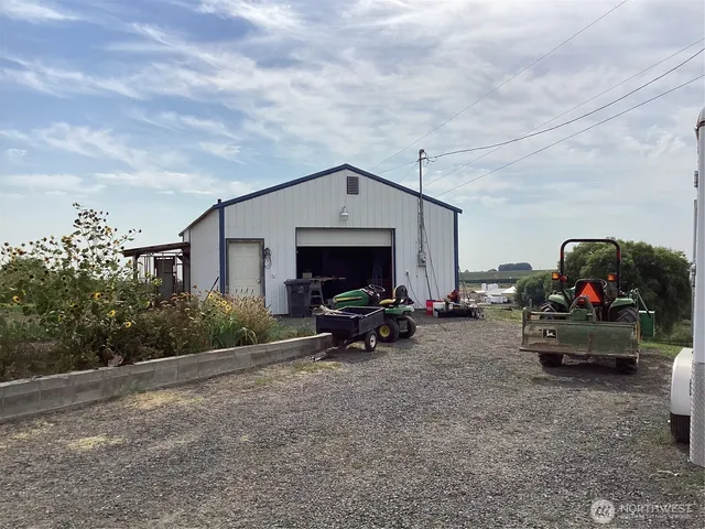 a view of a house with cars parked in front of house