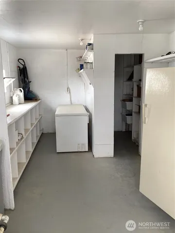 a utility room with cabinets dryer and washer