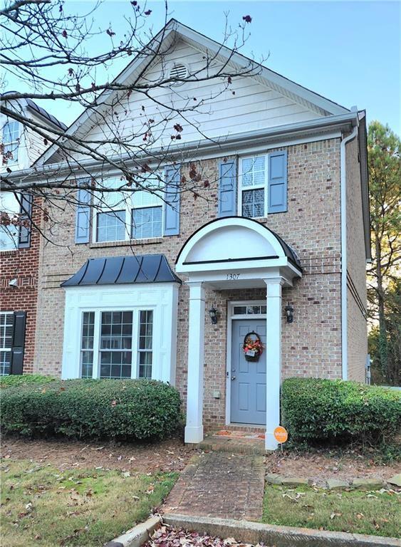 1307 Guilderoy Lane, Unit 4 Austell, GA 30106 - Photo 1 of 1 a front view of a house with garden