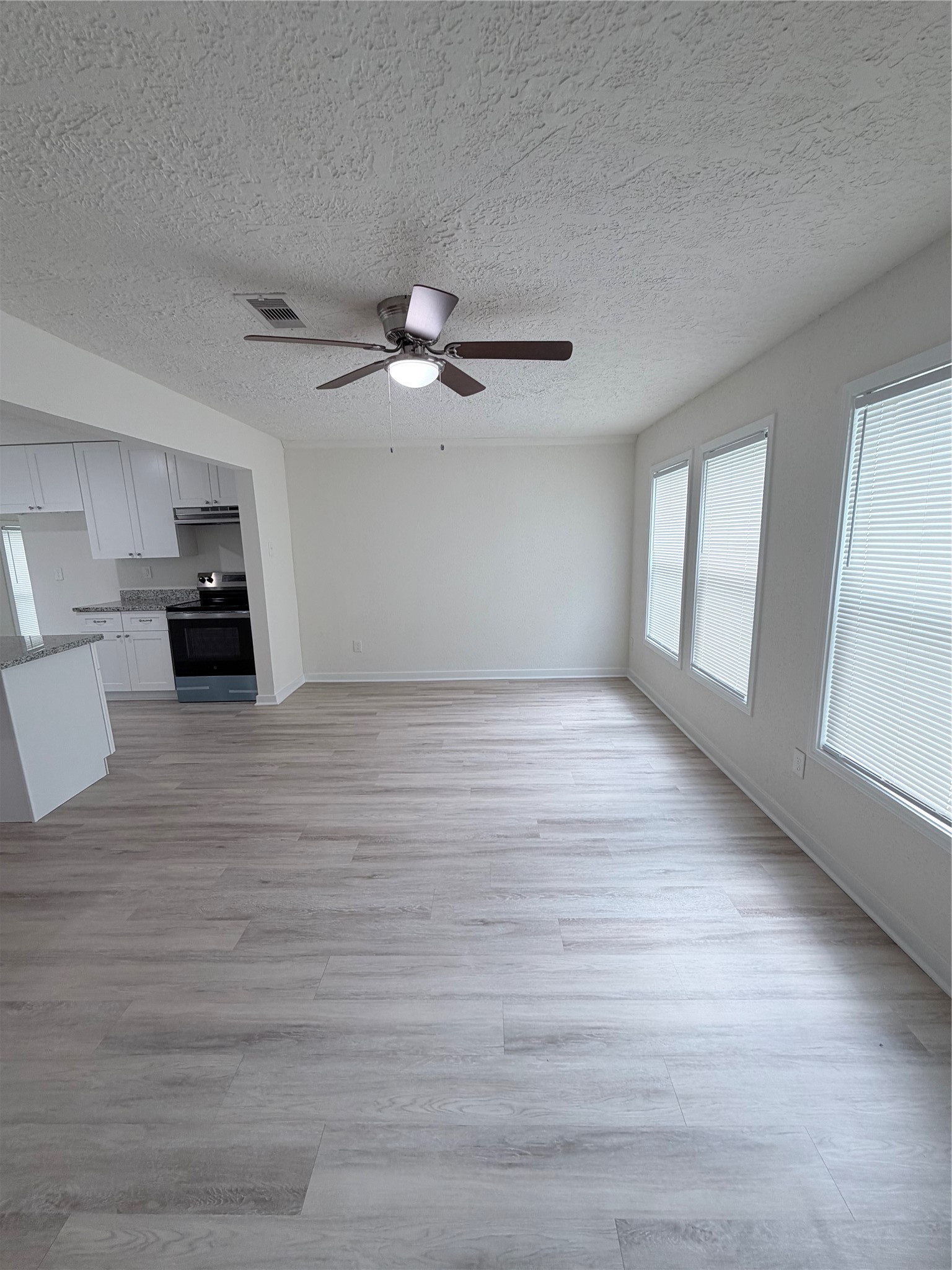 1112 3rd Street La Marque, TX 77568 - Photo 12 of 21 a view of an empty room with a window and wooden floor
