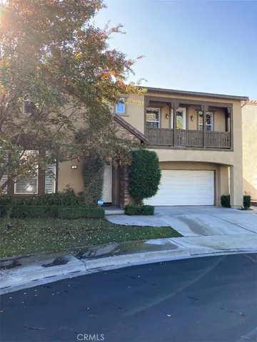 a front view of a house with a yard and a garage