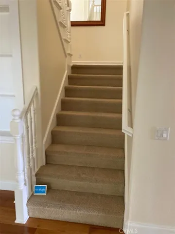 a kitchen with granite countertop a stove a sink and a refrigerator