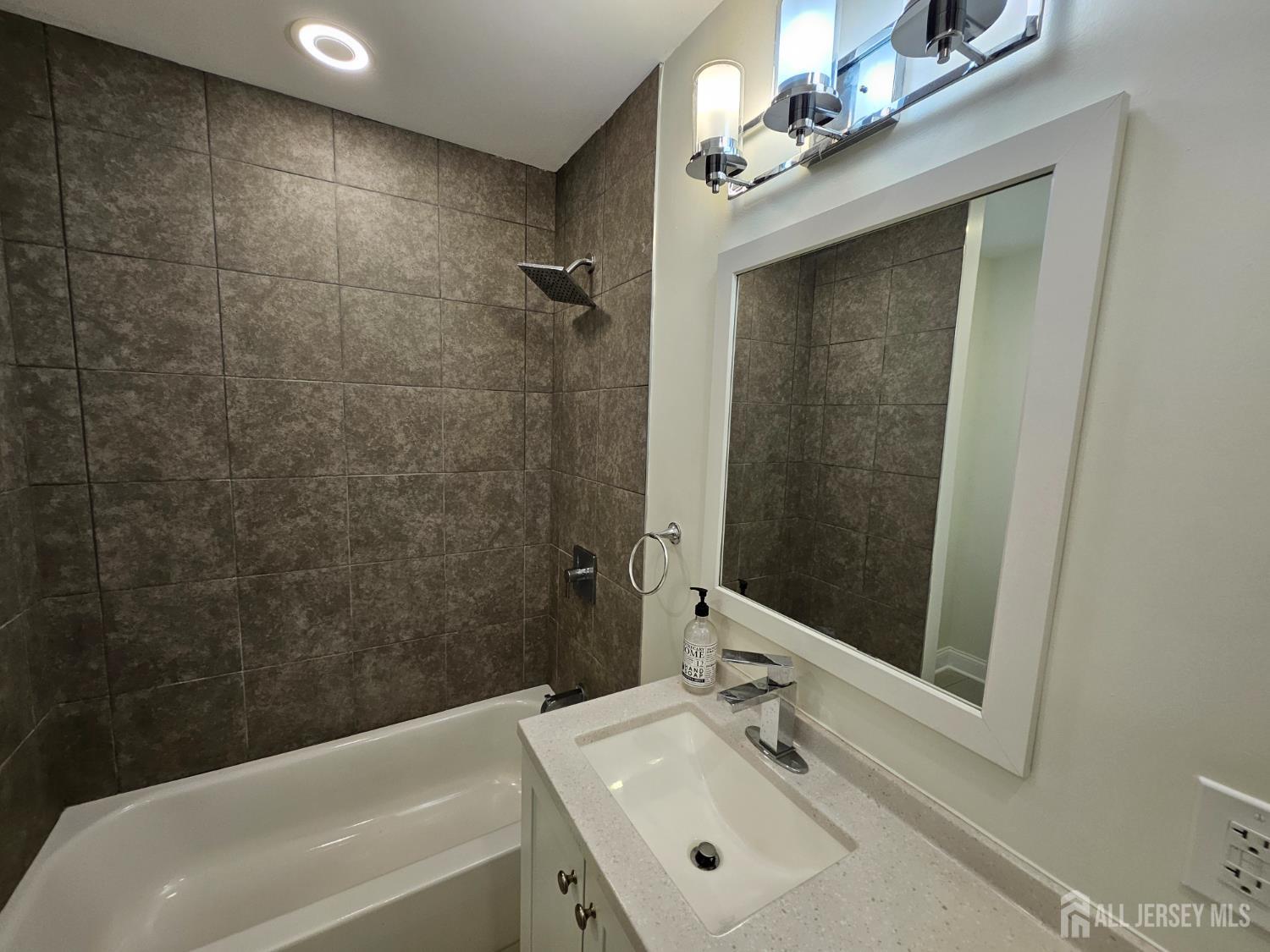 60 6th Avenue Trenton, NJ 08619 - Photo 14 of 28 a bathroom with a sink a toilet and shower