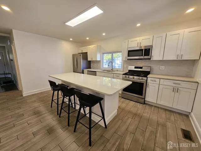 a spacious bathroom with a sink and a mirror