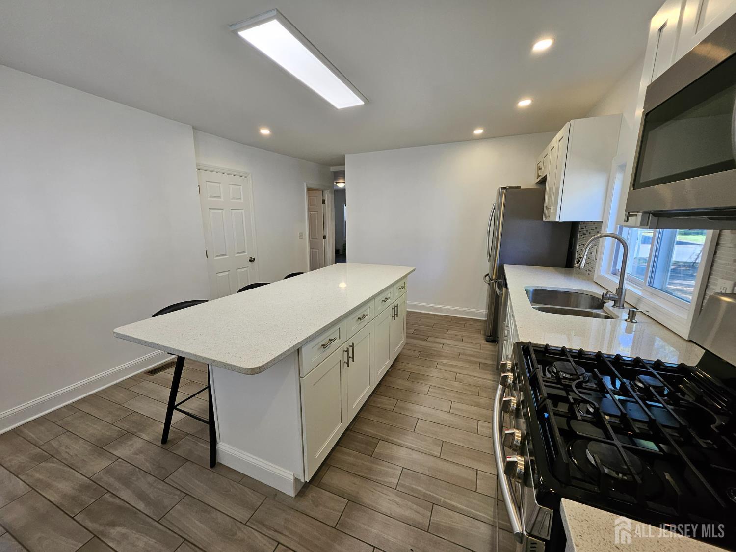 60 6th Avenue Trenton, NJ 08619 - Photo 21 of 28 a spacious bathroom with a sink and a mirror